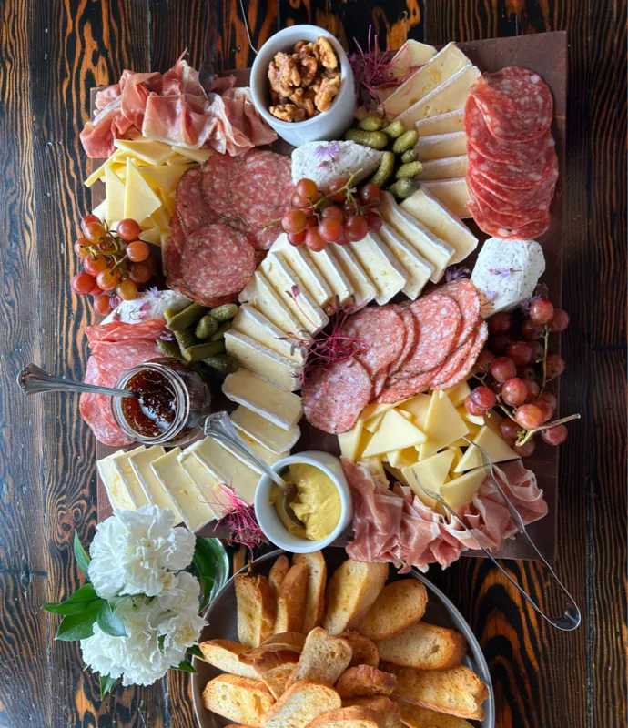 Artisanal charcuterie and cheese board with cured meats, fruits, and accompaniments